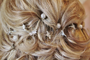 Woman with elegantly styled honey blond hair in a bun