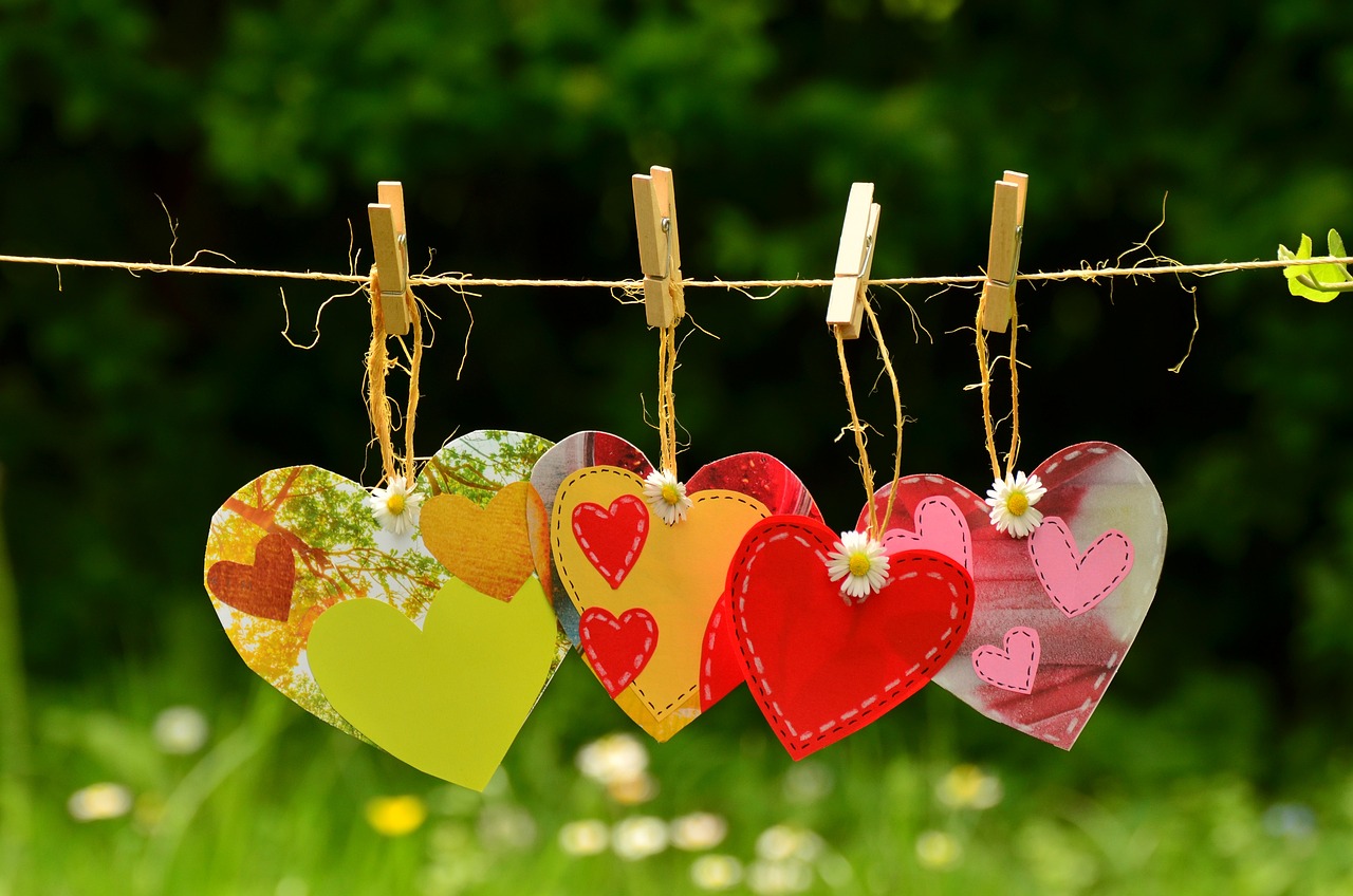 Five colorful hearts arranged in a row, representing the five love languages.