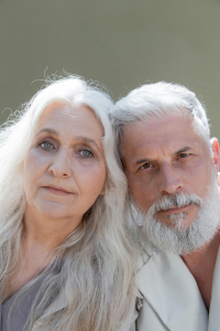 Confident couple with gray hair embracing their natural look