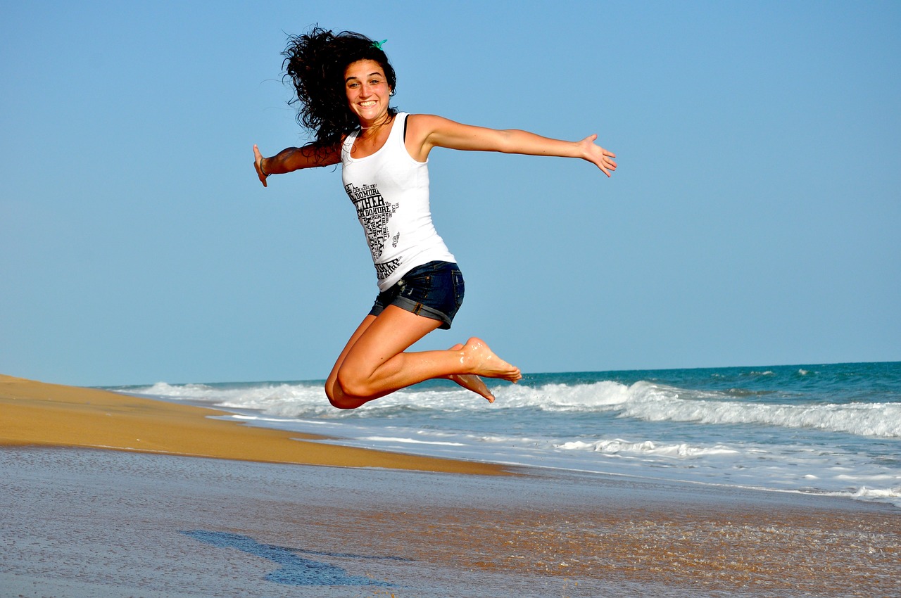 A happy woman enjoying a substance-free life outdoors.